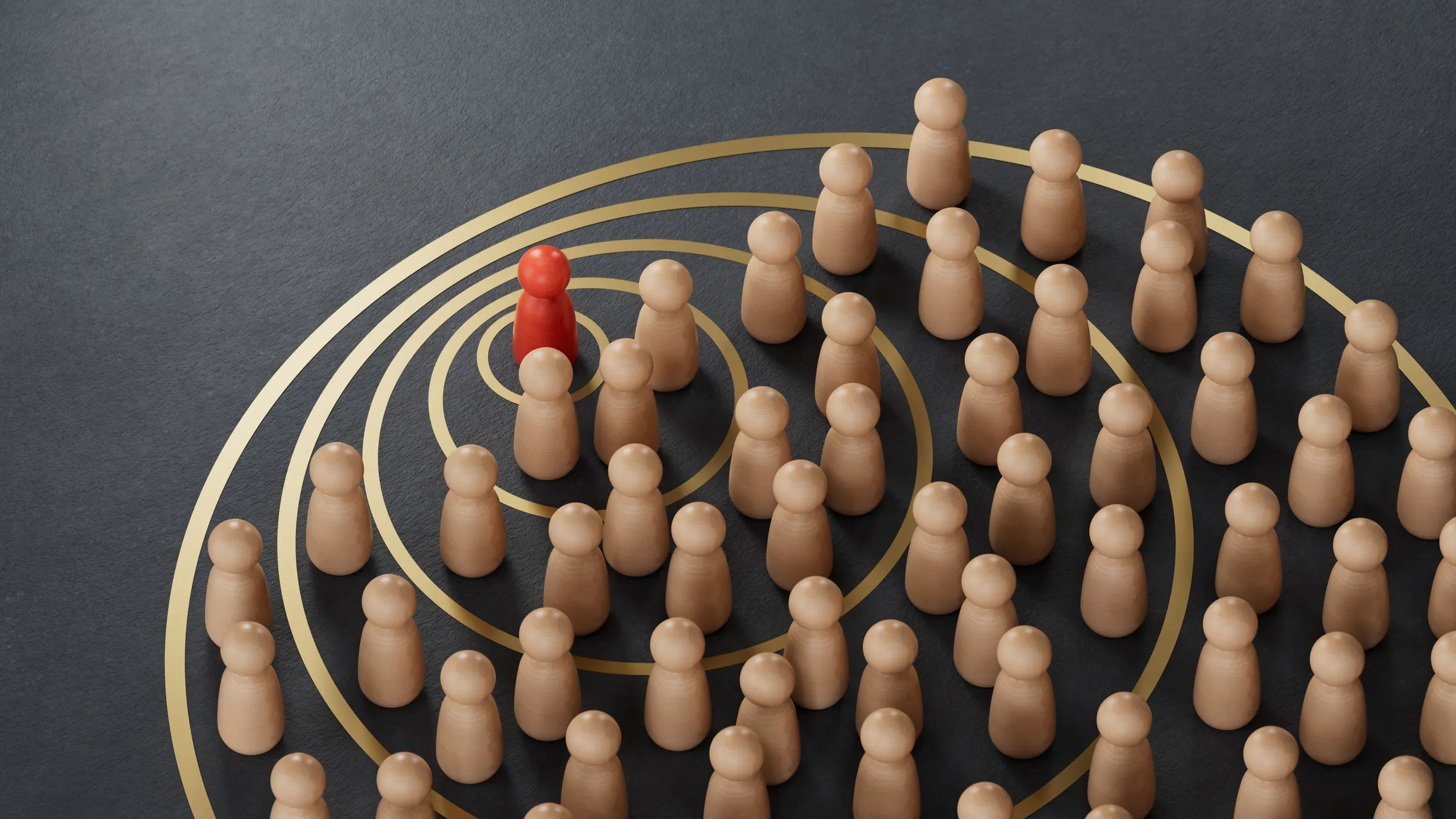 A red wooden figure stood before a large group of others without color; waves emitting from the red character indicate it's speaking to the group